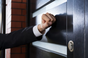 33084467 - close-up of hand knocking on the door